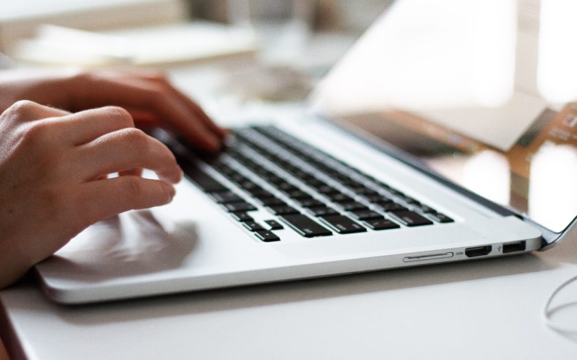 hands typing on a laptop